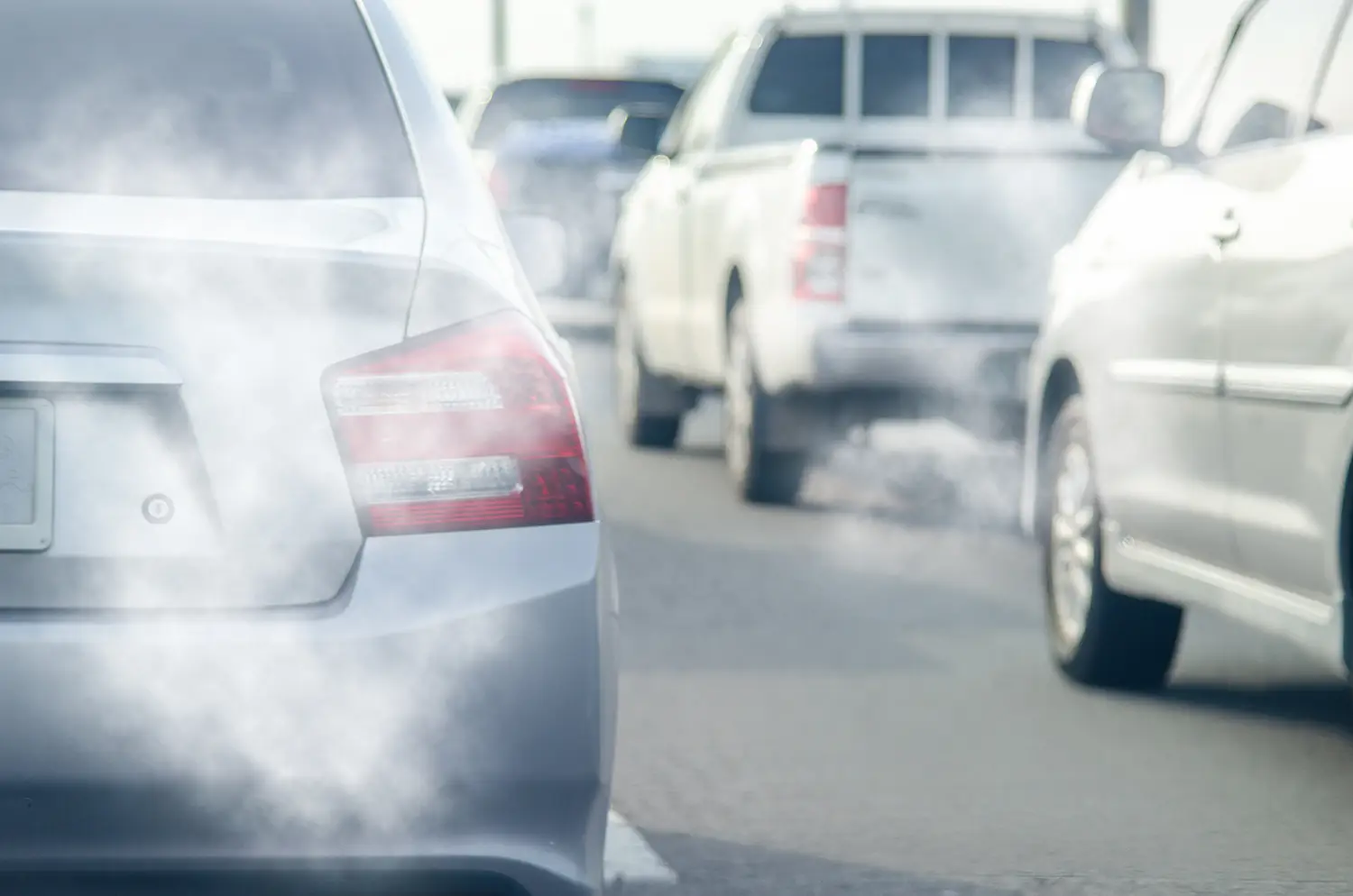 Running cars emitting harmful exhaust fumes